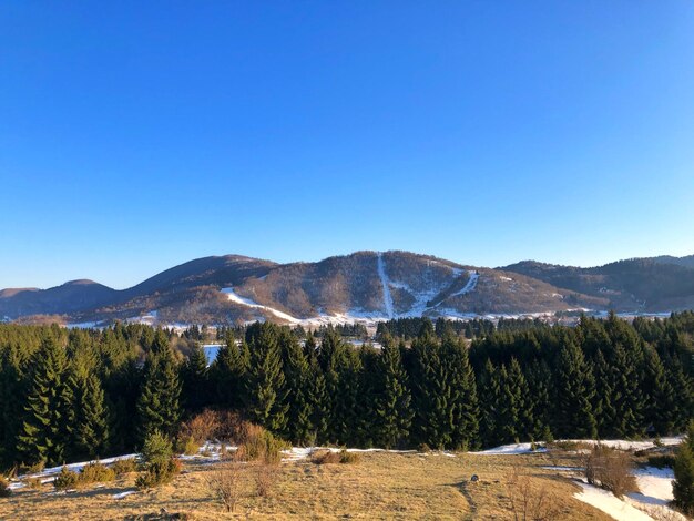 Scenic view of mountains against clear blue sky