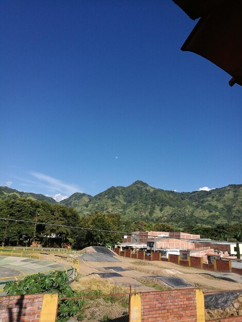 Scenic view of mountains against clear blue sky