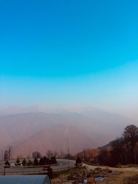 Scenic view of mountains against clear blue sky