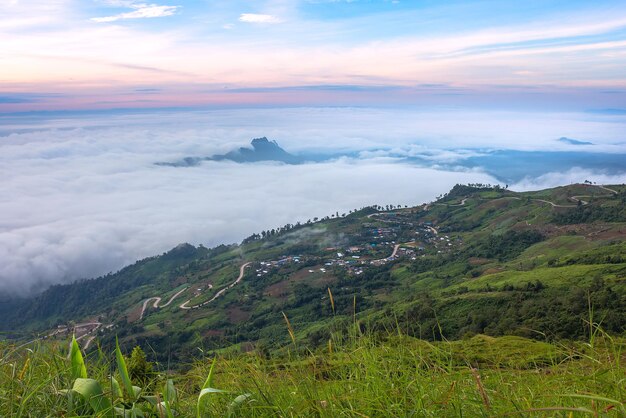 Scenic view of mountains against cloudy sky during sunset