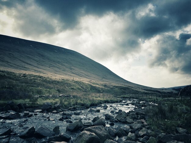 Scenic view of mountains against cloudy sky