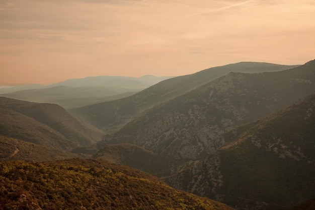 scenic view of mountains against cloudy sky