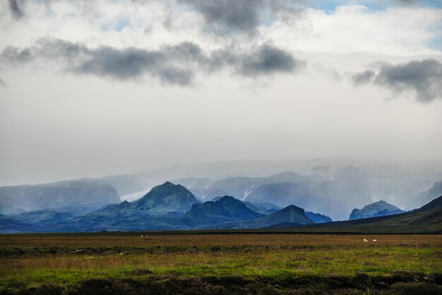 Scenic view of mountains against cloudy sky