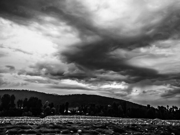 scenic view of mountains against cloudy sky