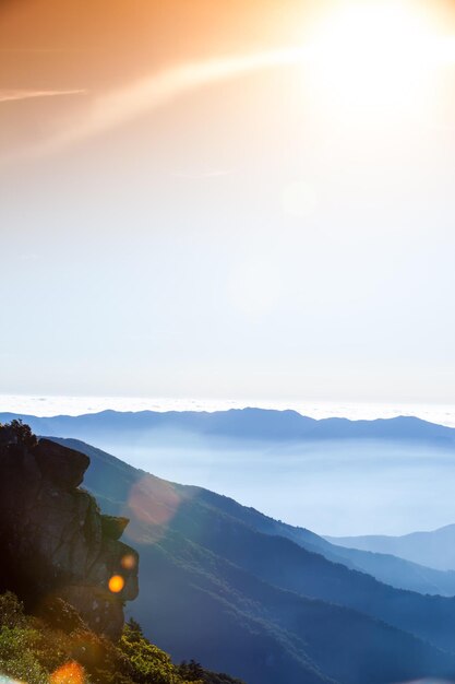 Photo scenic view of mountains against sky during sunset