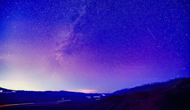 Scenic view of mountains against sky at night