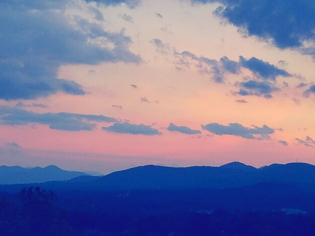 Scenic view of mountains against sky at sunset