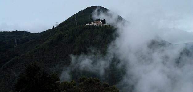 Photo scenic view of mountains in foggy weather