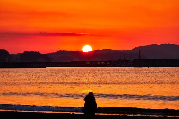 写真 日の出時の気まぐれな空に照らされた海の景色