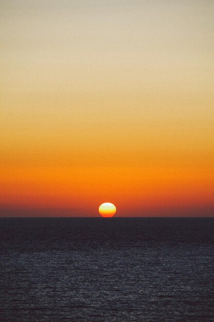 사진 오렌지색 하늘 을 배경 으로 한 바다 의 풍경