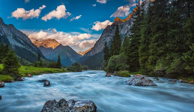 写真 天空を背景に岩を流れる小川の風景