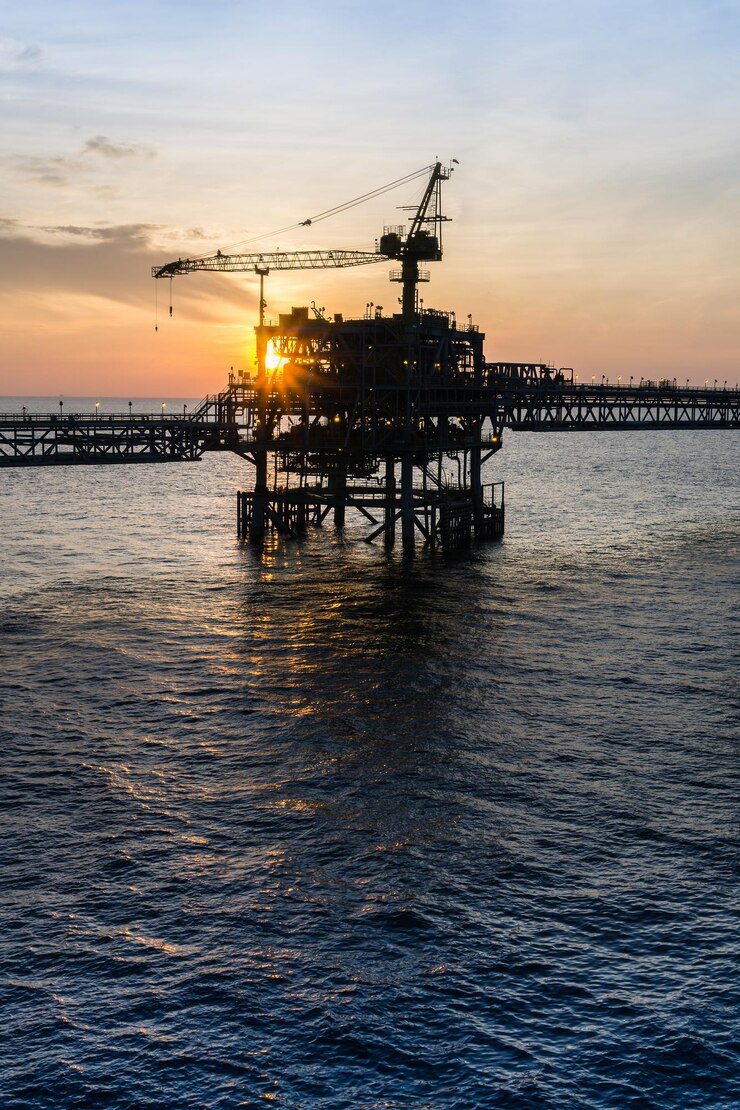 Photo scenic view of oil field against sky during sunset
