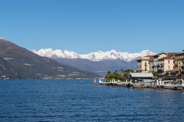 Scenic view of the port of menaggio italy with the snowy mountains in the background