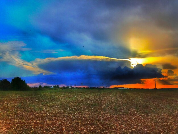 Scenic view of rainbow over field against sky