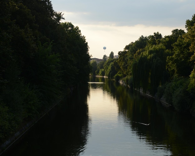 Scenic view of river against cloudy sky