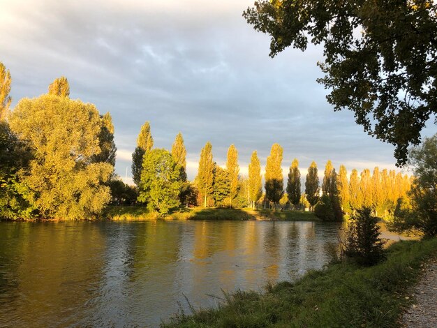 Scenic view of river against sky during autumn