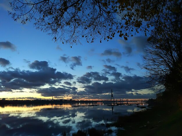 Scenic view of river against sky at sunset