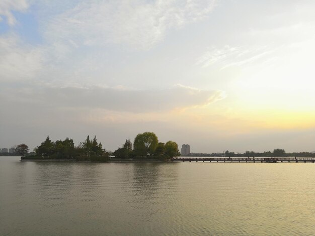 Scenic view of river against sky at sunset