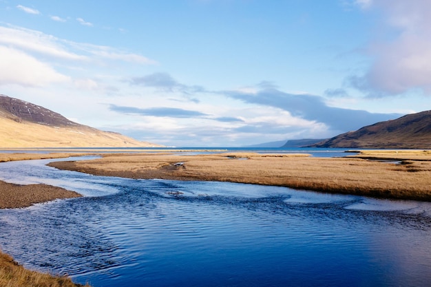 Scenic view of river and beach against sky