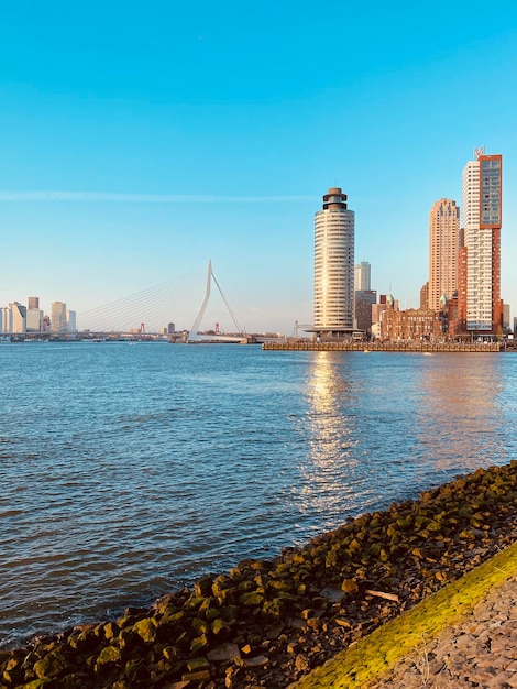 Scenic view of river by buildings against clear sky