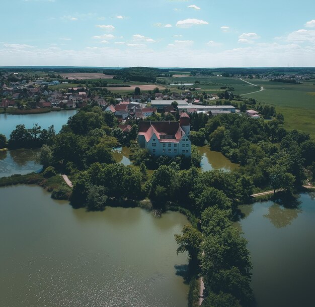 Scenic view of river by buildings against sky