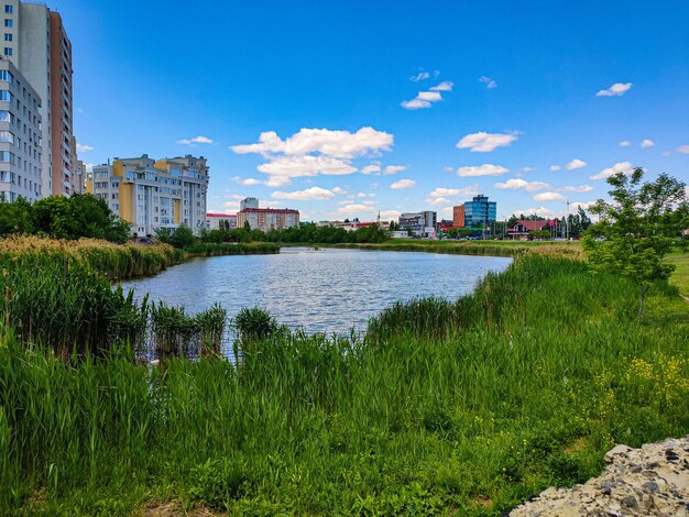 Scenic view of river by buildings against sky