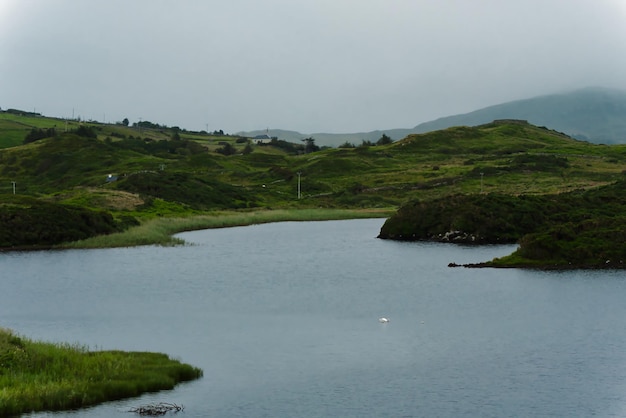 Scenic view of river by mountains against sky