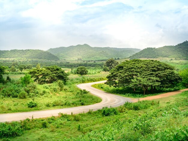 Scenic view of road by mountains against sky