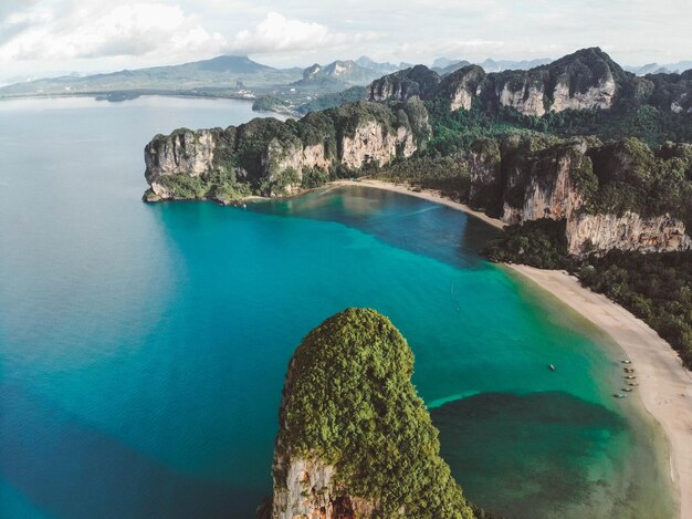 Scenic view of rock formations by sea against sky