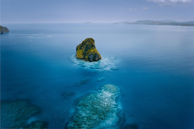 Scenic view of rock in sea against sky