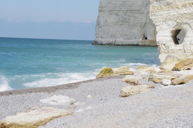 Scenic view of rocks on beach against sky