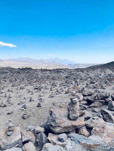 Scenic view of rocks on land against blue sky