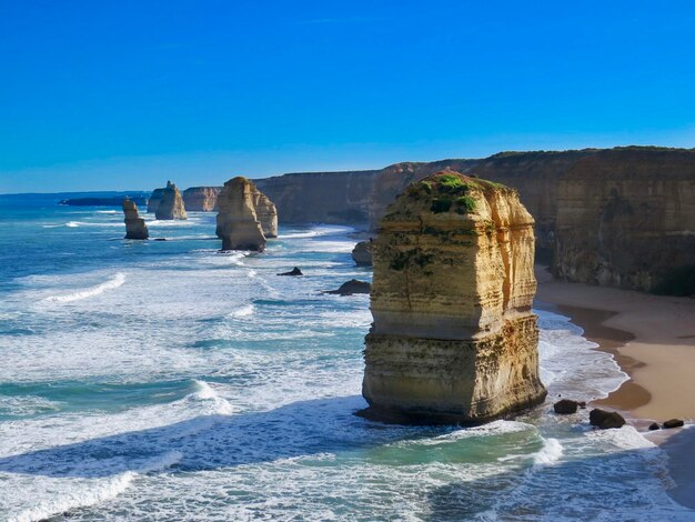 Scenic view of rocks in sea against blue sky