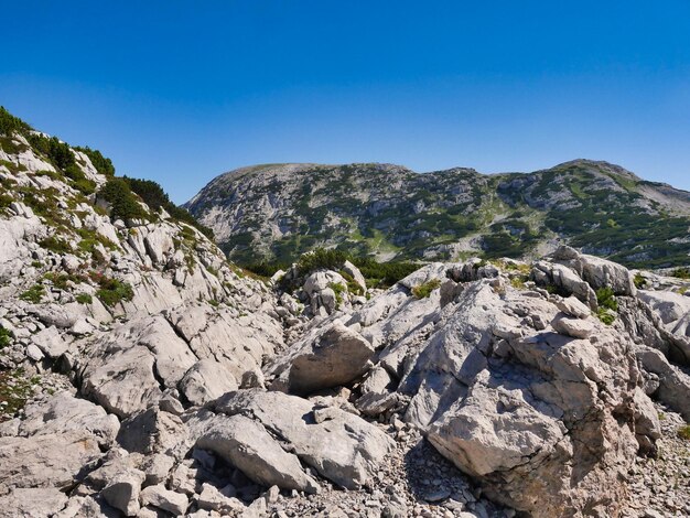 Scenic view of rocky mountains against clear blue sky