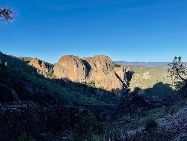 Scenic view of rocky mountains against clear blue sky