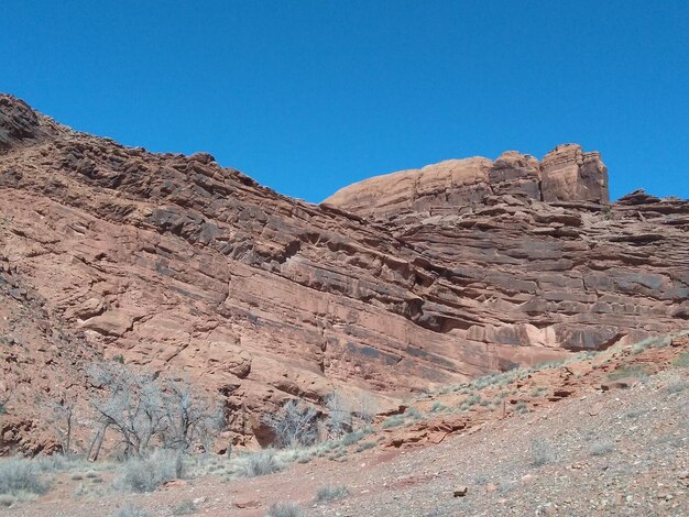 Scenic view of rocky mountains against clear blue sky