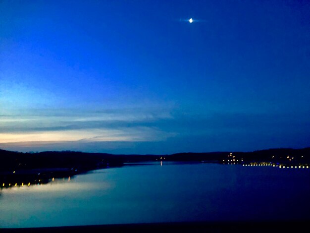 Scenic view of sea against blue sky at night