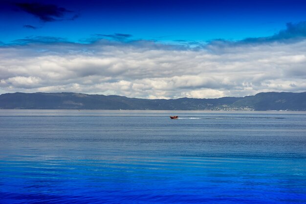 Scenic view of sea against blue sky