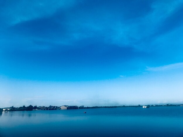 Scenic view of sea against blue sky