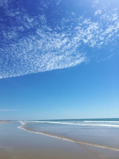 Scenic view of sea against blue sky