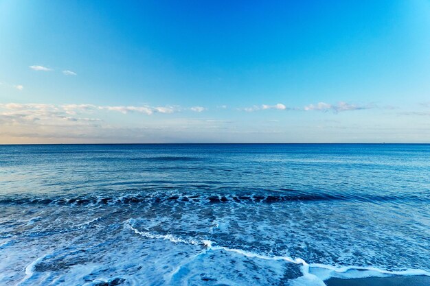 Scenic view of sea against blue sky