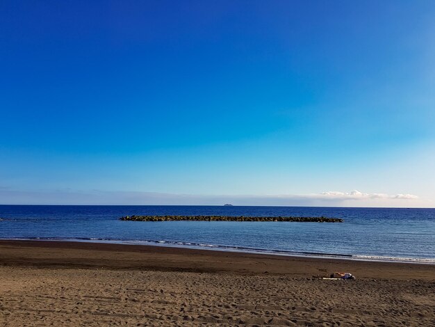 Scenic view of sea against blue sky