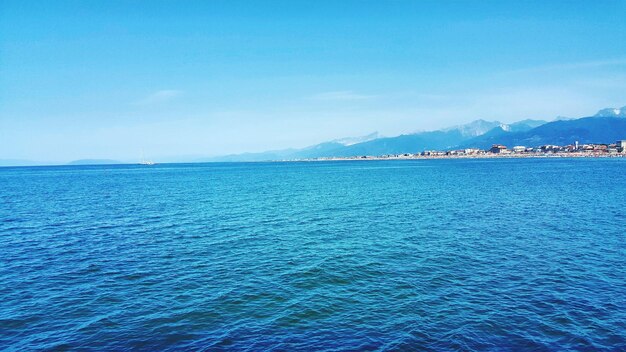 Scenic view of sea against blue sky