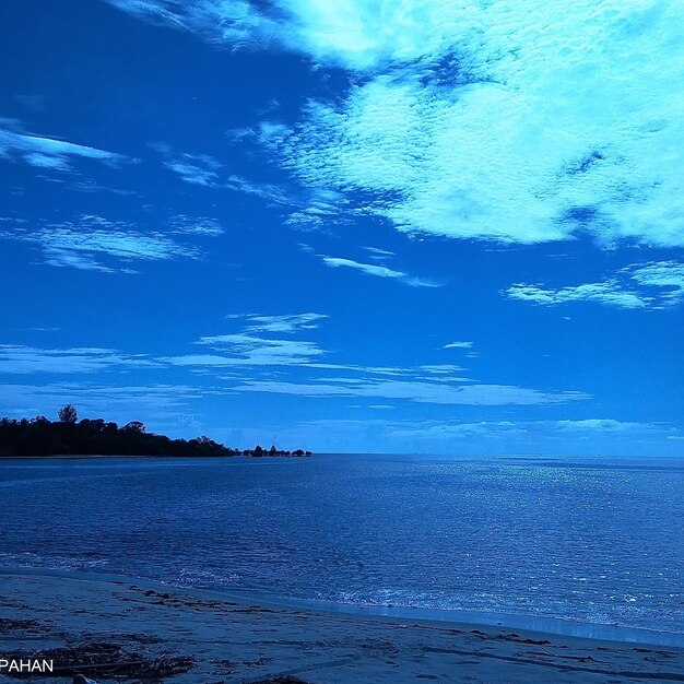 Scenic view of sea against blue sky