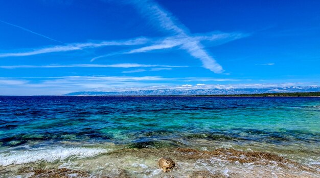 Scenic view of sea against blue sky