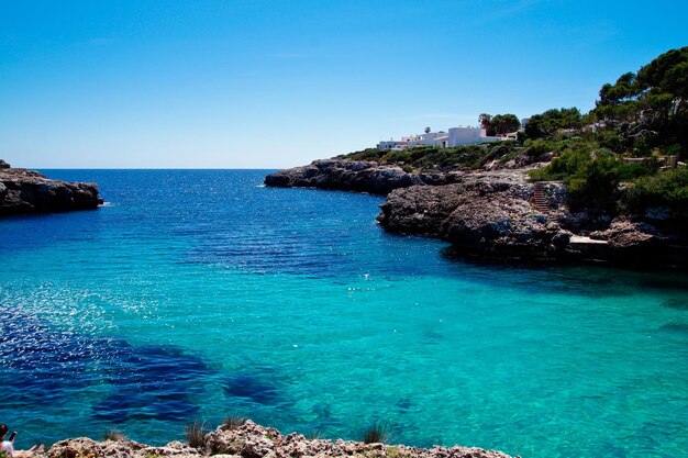 Scenic view of sea against clear blue sky cala dor