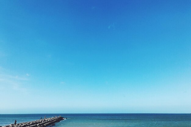 Scenic view of sea against clear blue sky