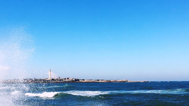 Scenic view of sea against clear blue sky