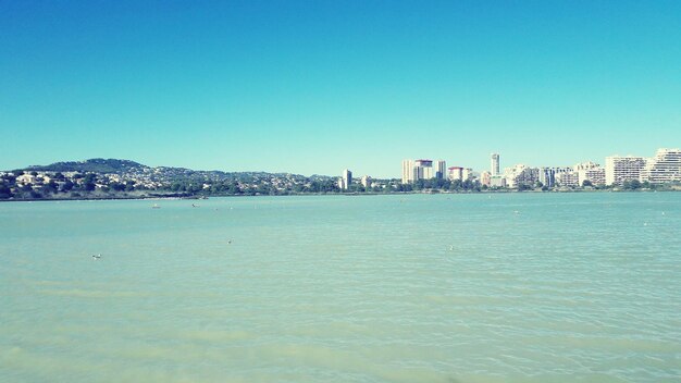 Scenic view of sea against clear blue sky