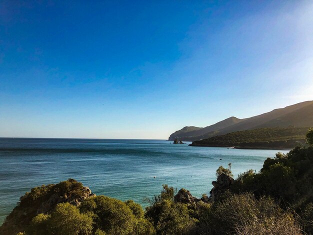 Scenic view of sea against clear blue sky